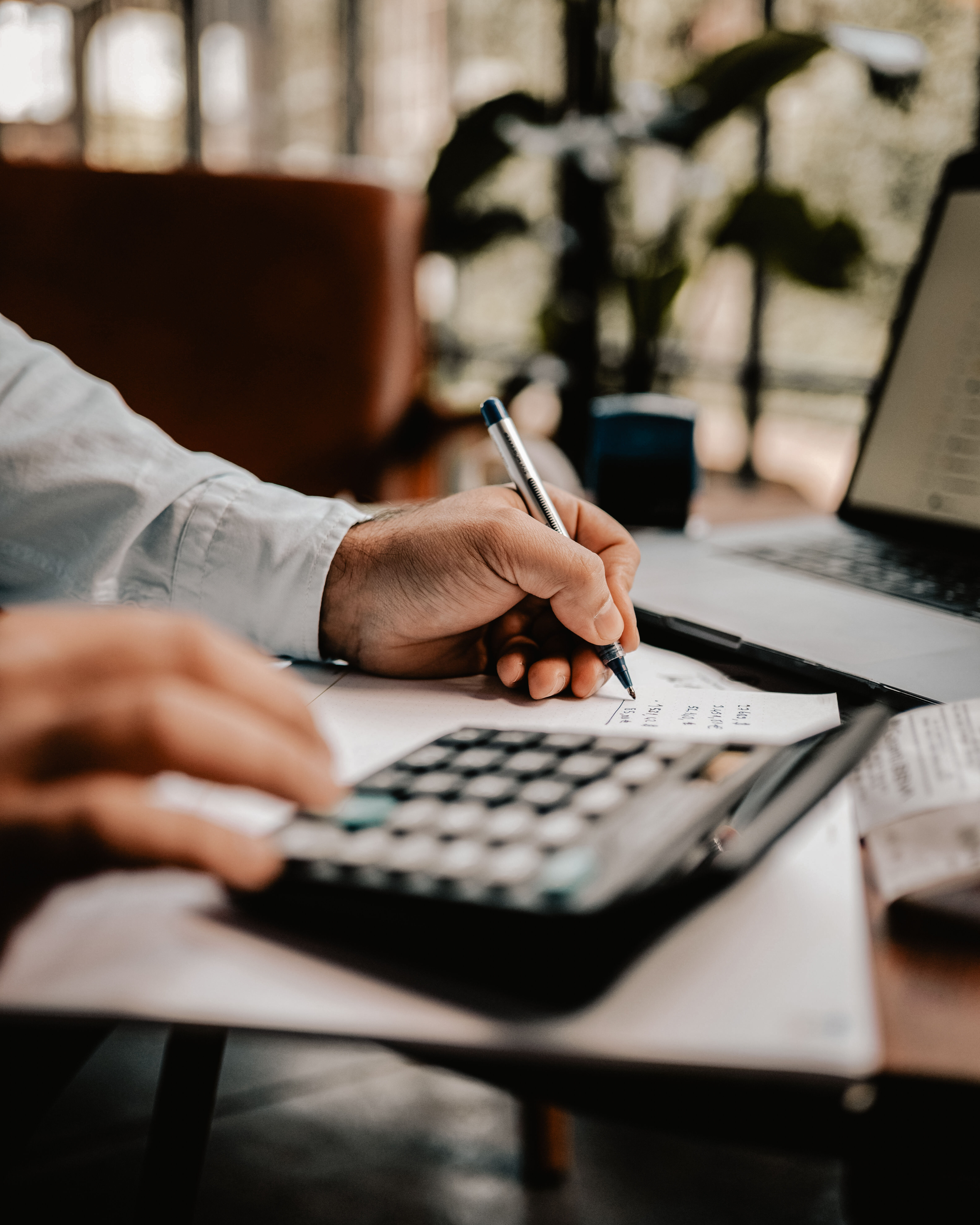 Businessman performing calculations with financial paperwork